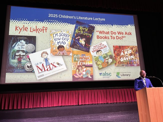 Image of Kyle Lukoff as he presents the 2025 Children's Literature Lecture