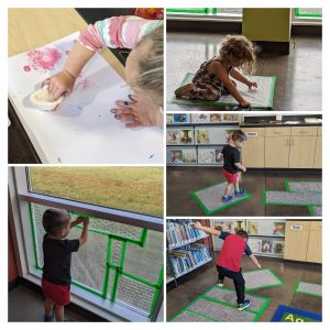 Kids painting with bubble wrap, popping it on the floor and on the window.