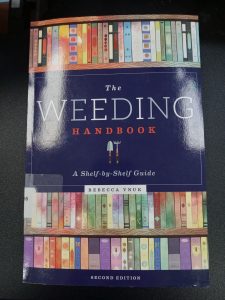 The book "The Weeding Handbook" sits on a desk.