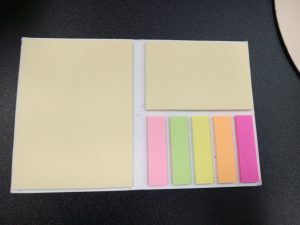A pad features sticky notes in three different sizes: half sheet, quarter sheet, and small strips.
