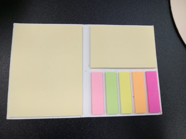 A pad features sticky notes in three different sizes: half sheet, quarter sheet, and small strips.