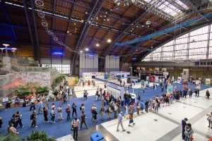 A wide shot of ALA Annual event attendees walking on the exhibit floor.