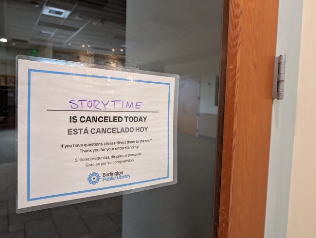 A canceled sign is posted on a library door.