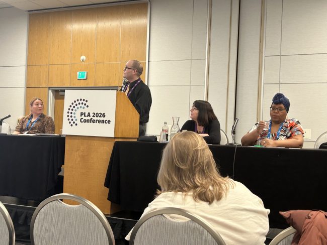 Panelists seated and standing at a PLA 2026 session about the rebooted DigitalLearn.org.